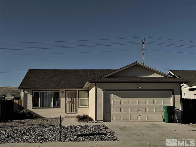 ranch-style house featuring driveway, a garage, and fence