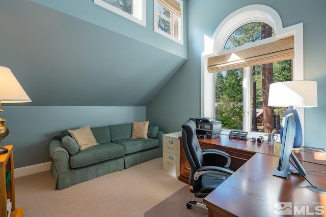 carpeted office space featuring vaulted ceiling