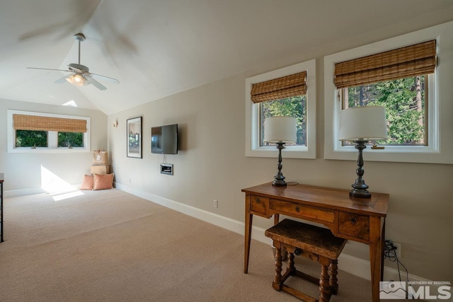 interior space with baseboards, a ceiling fan, and vaulted ceiling