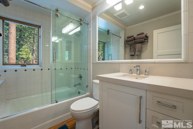 full bathroom with vanity, ornamental molding, enclosed tub / shower combo, toilet, and visible vents