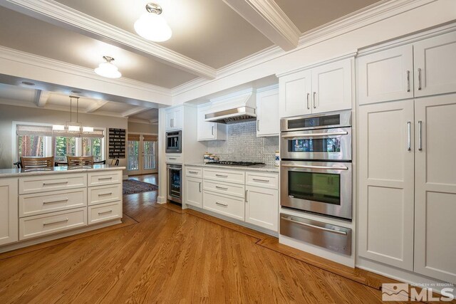 kitchen featuring light wood-style floors, beamed ceiling, double oven, custom exhaust hood, and a warming drawer