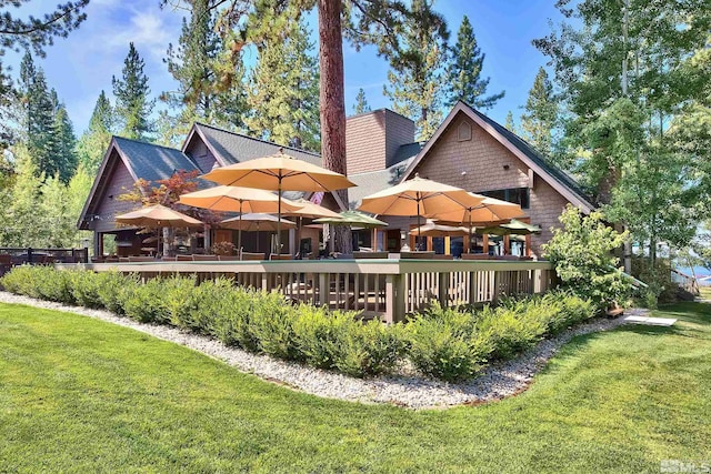 back of house featuring a yard and a wooden deck