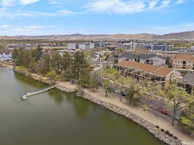 birds eye view of property with a water and mountain view