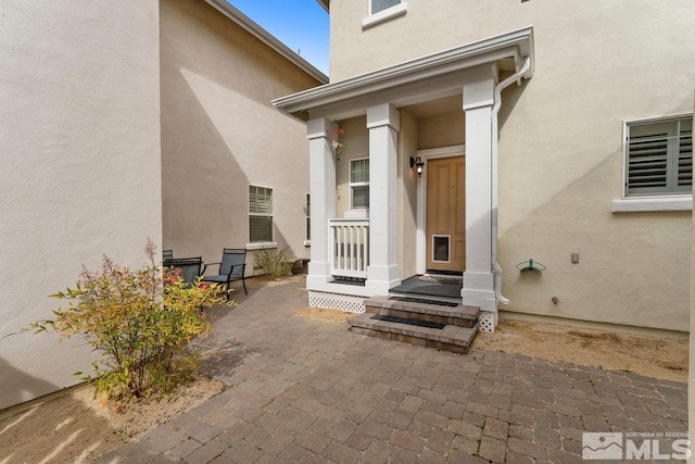 property entrance featuring stucco siding
