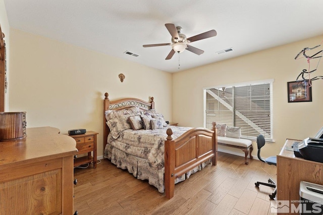 bedroom featuring visible vents, ceiling fan, and light wood-style flooring
