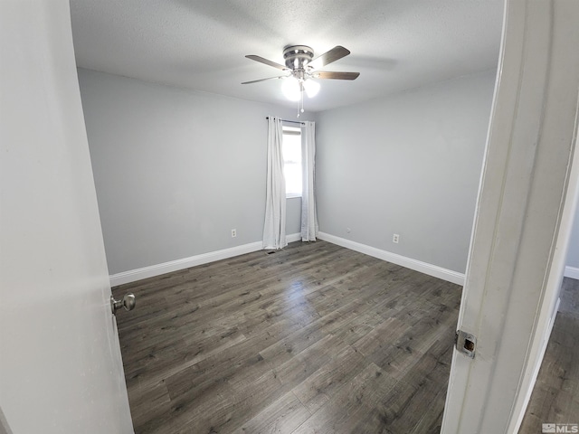 spare room featuring a textured ceiling, baseboards, a ceiling fan, and wood finished floors