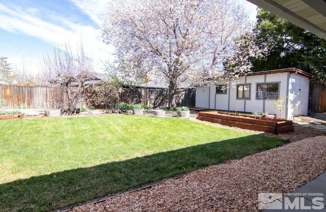 view of yard featuring an outbuilding and a fenced backyard