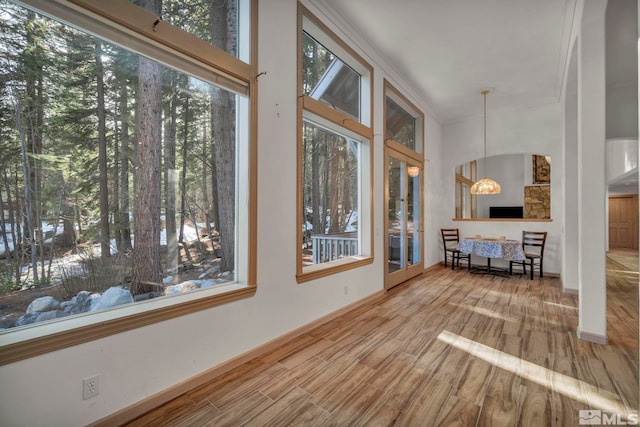 sunroom featuring french doors and a notable chandelier