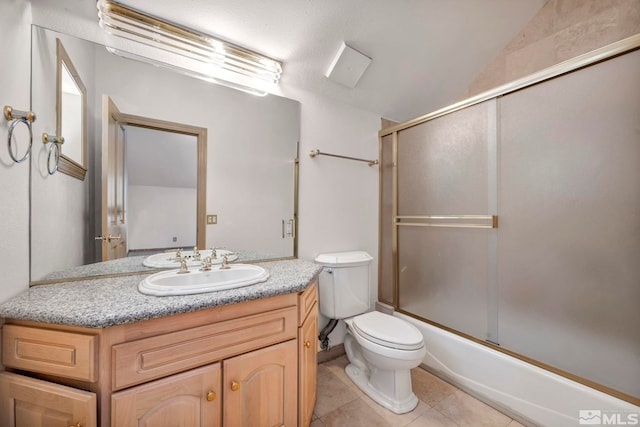 bathroom with shower / bath combination with glass door, vanity, vaulted ceiling, tile patterned flooring, and toilet