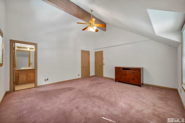 unfurnished bedroom featuring high vaulted ceiling, light colored carpet, and baseboards