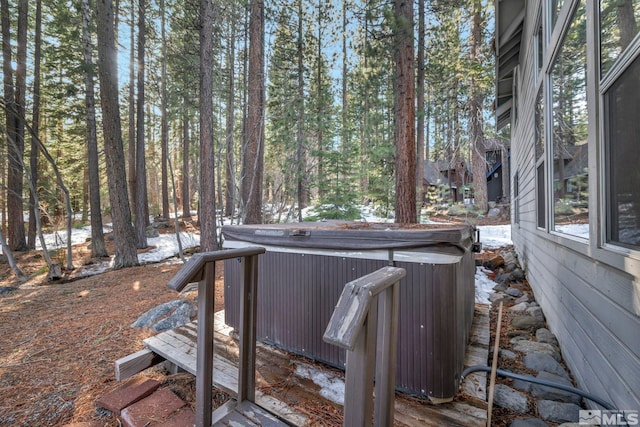wooden terrace featuring a hot tub