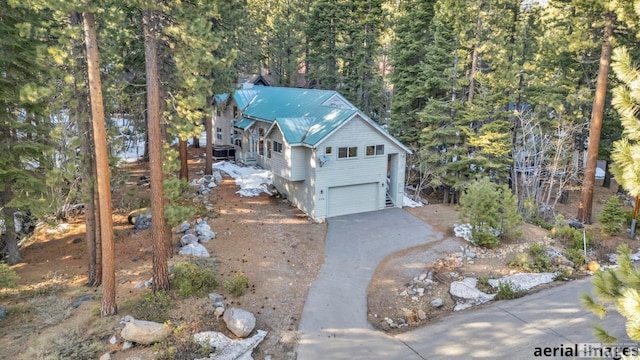 birds eye view of property featuring a view of trees