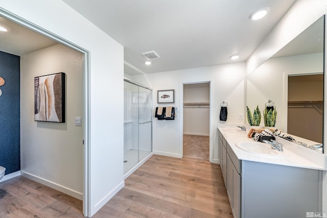 bathroom featuring a sink, visible vents, and wood finished floors