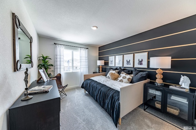 carpeted bedroom featuring a textured ceiling