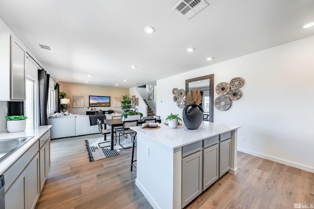 kitchen with gray cabinetry, visible vents, and light countertops