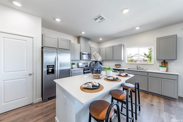 kitchen featuring gray cabinets and appliances with stainless steel finishes