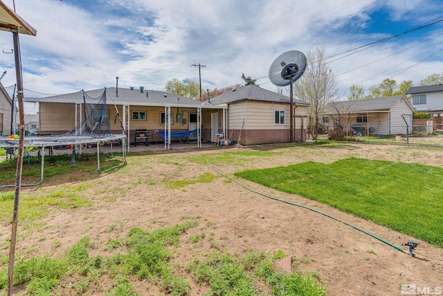 view of yard with fence and a trampoline