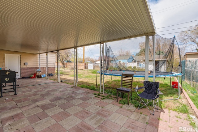 view of patio / terrace with a trampoline and a fenced backyard