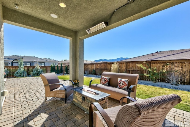 view of patio / terrace with an outdoor living space with a fire pit and a fenced backyard