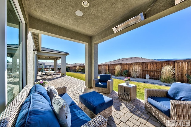 view of patio featuring an outdoor living space, outdoor dining area, and fence