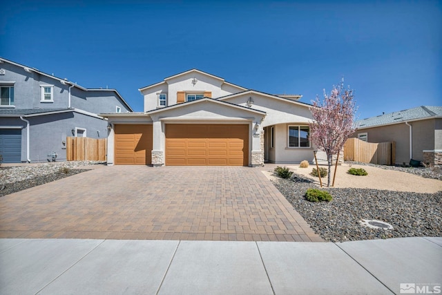 traditional home with fence, stucco siding, decorative driveway, and an attached garage