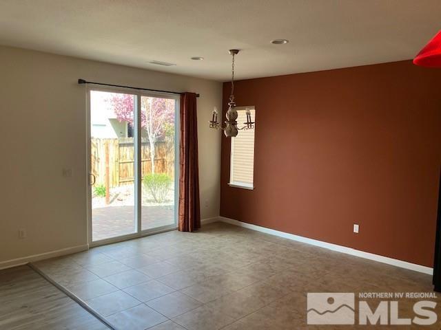 spare room with baseboards, recessed lighting, and an inviting chandelier