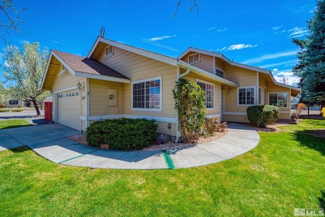view of front of home with concrete driveway, a front lawn, and an attached garage