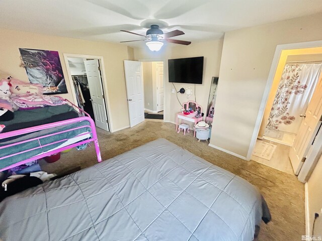 carpeted bedroom with a closet, baseboards, and ceiling fan