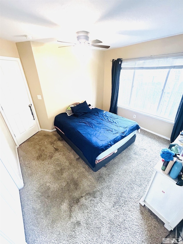 bedroom with carpet flooring, baseboards, and a ceiling fan