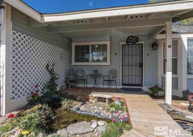 view of exterior entry with a porch