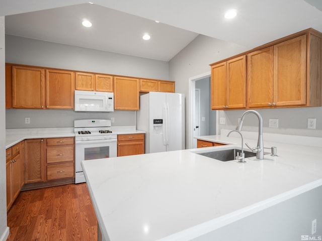 kitchen with white appliances, light countertops, a peninsula, dark wood-style flooring, and recessed lighting