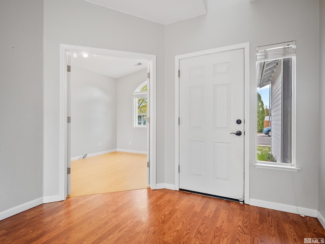 entrance foyer with light wood finished floors and baseboards