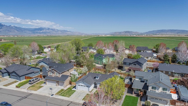 bird's eye view featuring a rural view, a residential view, and a mountain view