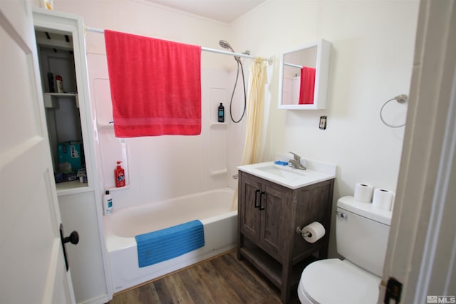 bathroom with toilet, wood finished floors, vanity, and shower / tub combo with curtain