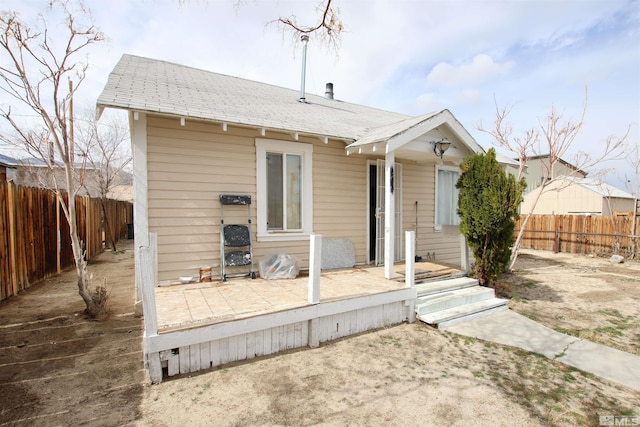 view of front facade featuring a patio and a fenced backyard