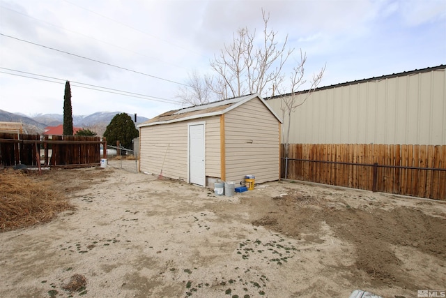 garage with fence and a mountain view