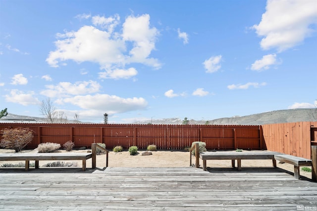 deck featuring a fenced backyard and a mountain view