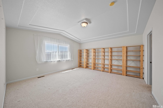 bonus room with baseboards, vaulted ceiling, visible vents, and carpet