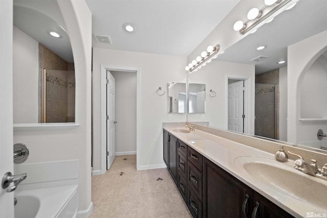 full bathroom with a tile shower, a sink, visible vents, and double vanity