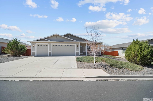 ranch-style house featuring an attached garage, driveway, and fence