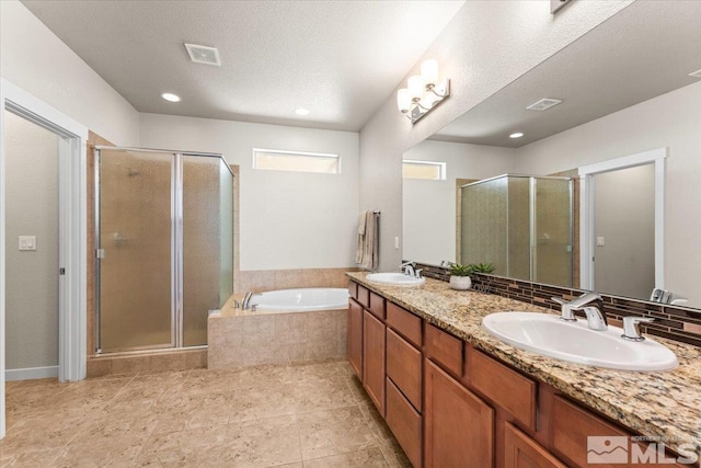 full bath featuring a bath, a shower stall, a sink, and visible vents