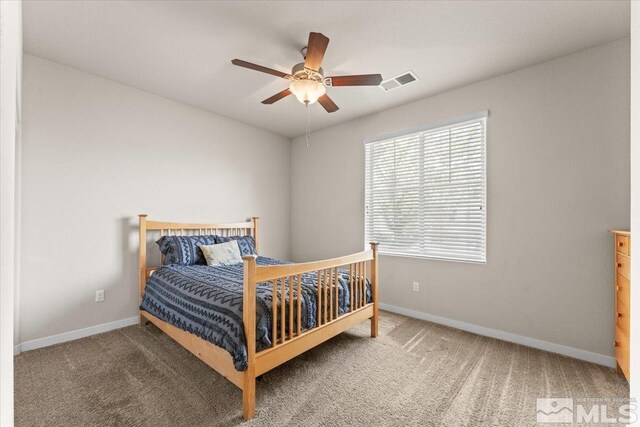 bedroom with carpet, visible vents, baseboards, and ceiling fan