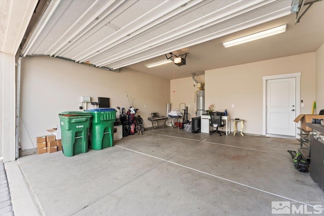 garage featuring secured water heater and a garage door opener