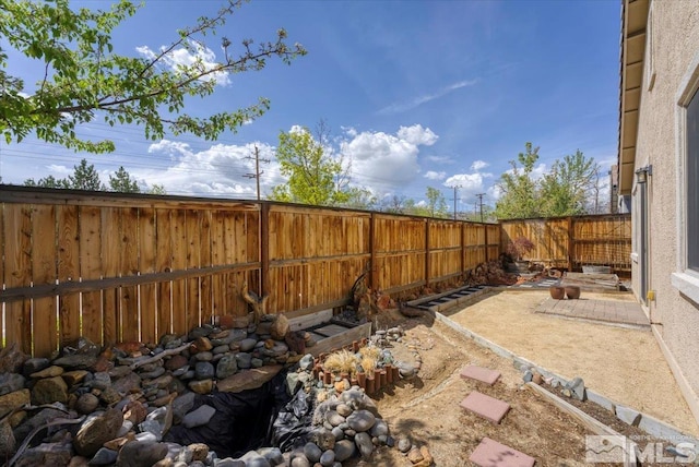 view of yard with a patio area and a fenced backyard