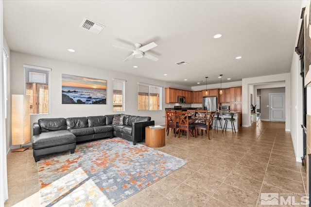 living area featuring recessed lighting, visible vents, and a ceiling fan