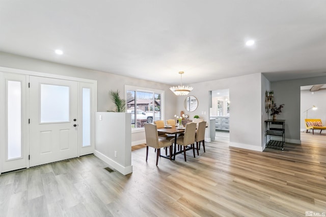 dining area featuring baseboards, light wood finished floors, visible vents, and recessed lighting
