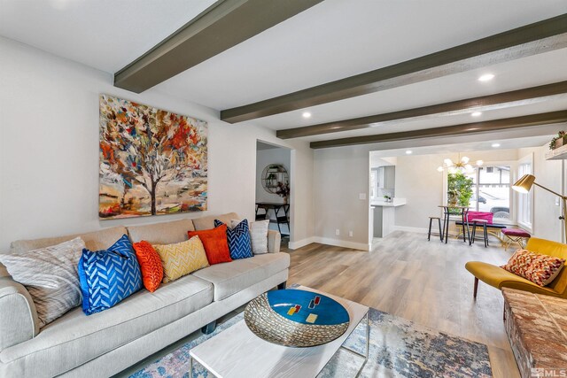 living area with recessed lighting, wood finished floors, beam ceiling, baseboards, and a chandelier