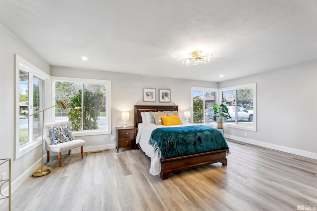 bedroom with recessed lighting, a chandelier, light wood finished floors, and baseboards