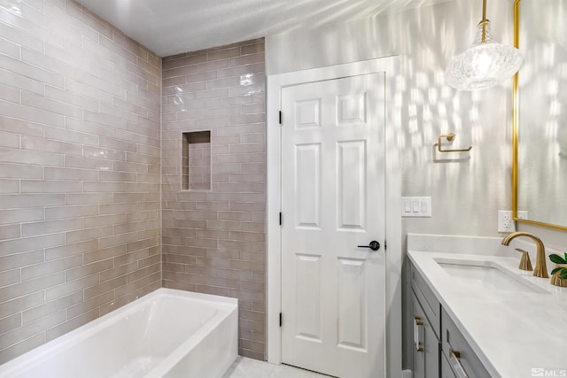 full bath with tile patterned floors, vanity, and washtub / shower combination