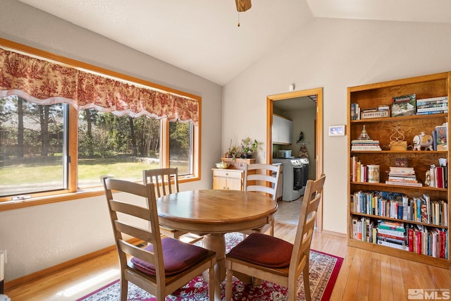 dining room featuring lofted ceiling, a ceiling fan, and light wood-style flooring